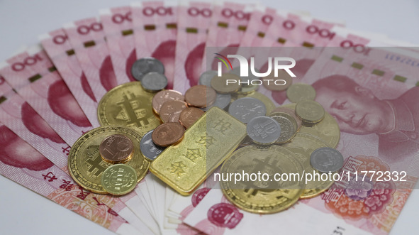 A photo taken in Huaian, China, on November 13, 2024, shows bitcoin and the Chinese yuan. 