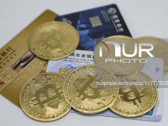 A photo taken in Huaian, China, on November 13, 2024, shows bitcoin and the Chinese yuan. (