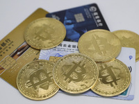 A photo taken in Huaian, China, on November 13, 2024, shows bitcoin and the Chinese yuan. (