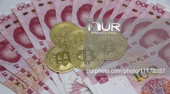 A photo taken in Huaian, China, on November 13, 2024, shows bitcoin and the Chinese yuan. 