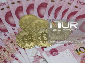 A photo taken in Huaian, China, on November 13, 2024, shows bitcoin and the Chinese yuan. (