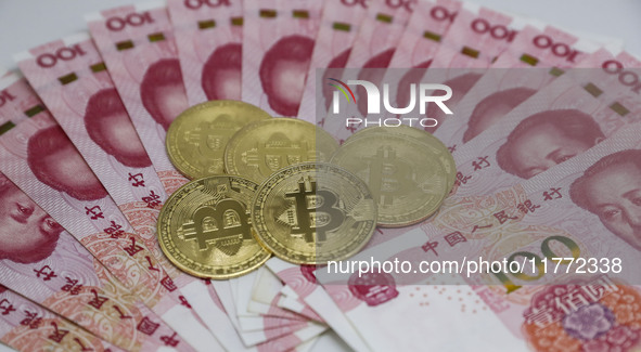 A photo taken in Huaian, China, on November 13, 2024, shows bitcoin and the Chinese yuan. 