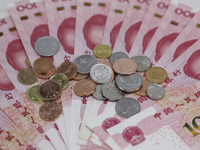 A photo taken in Huaian, China, on November 13, 2024, shows bitcoin and the Chinese yuan. (