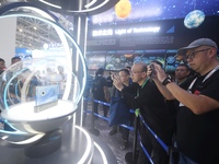 Visitors look at samples of lunar soil from the far side of the moon on display at the 2024 Zhuhai Air Show in Zhuhai, China, on November 13...