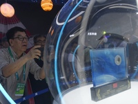 Visitors look at samples of lunar soil from the far side of the moon on display at the 2024 Zhuhai Air Show in Zhuhai, China, on November 13...