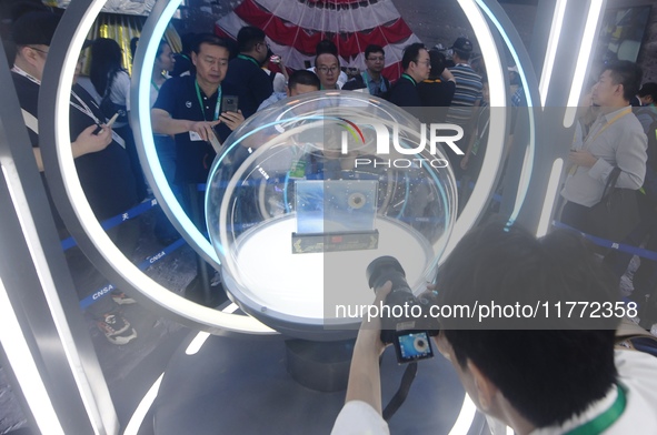 Visitors look at samples of lunar soil from the far side of the moon on display at the 2024 Zhuhai Air Show in Zhuhai, China, on November 13...