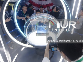 Visitors look at samples of lunar soil from the far side of the moon on display at the 2024 Zhuhai Air Show in Zhuhai, China, on November 13...