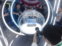 Visitors look at samples of lunar soil from the far side of the moon on display at the 2024 Zhuhai Air Show in Zhuhai, China, on November 13...