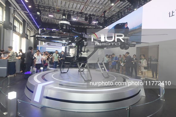 Visitors view the electric vertical take-off and landing unmanned manned aircraft (eVTOL) of Aeroht's split flying car at the 2024 Zhuhai Ai...