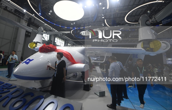 Visitors view a Chinese-made 6-ton tilt-rotor unmanned cargo aircraft at the 2024 Zhuhai Air Show in Zhuhai, China, on November 13, 2024. 