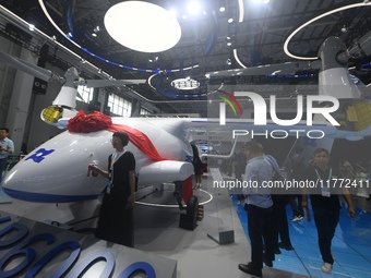 Visitors view a Chinese-made 6-ton tilt-rotor unmanned cargo aircraft at the 2024 Zhuhai Air Show in Zhuhai, China, on November 13, 2024. (