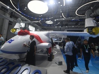 Visitors view a Chinese-made 6-ton tilt-rotor unmanned cargo aircraft at the 2024 Zhuhai Air Show in Zhuhai, China, on November 13, 2024. (