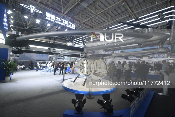 Visitors view an electric vertical take-off and landing unmanned manned aircraft (eVTOL) at the 2024 Zhuhai Air Show in Zhuhai, China, on No...