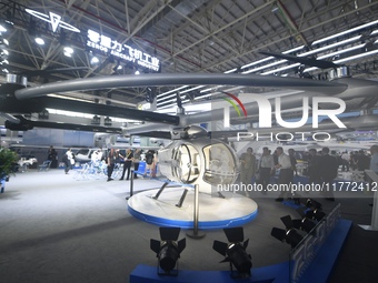 Visitors view an electric vertical take-off and landing unmanned manned aircraft (eVTOL) at the 2024 Zhuhai Air Show in Zhuhai, China, on No...