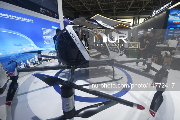 Visitors view the electric vertical take-off and landing unmanned manned aircraft (eVTOL) of XOPeng Huitian's split flying car at the 2024 Z...