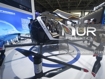 Visitors view the electric vertical take-off and landing unmanned manned aircraft (eVTOL) of XOPeng Huitian's split flying car at the 2024 Z...