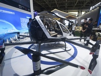 Visitors view the electric vertical take-off and landing unmanned manned aircraft (eVTOL) of XOPeng Huitian's split flying car at the 2024 Z...