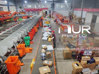 Workers of a courier company sort packages on a smart express line in Enshi, Hubei province, China, on November 13, 2024. (