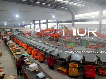 Workers of a courier company sort packages on a smart express line in Enshi, Hubei province, China, on November 13, 2024. (