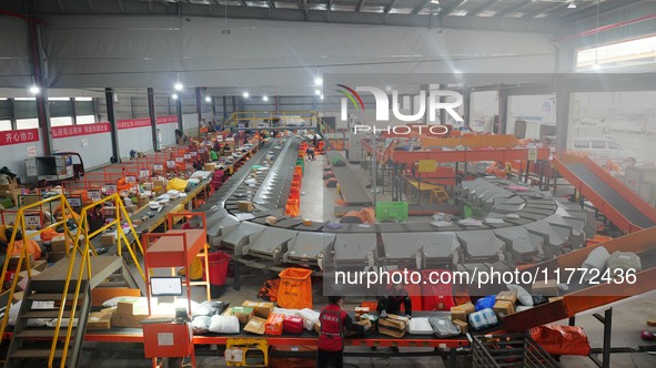 Workers of a courier company sort packages on a smart express line in Enshi, Hubei province, China, on November 13, 2024. 