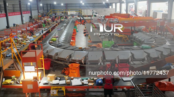 Workers of a courier company sort packages on a smart express line in Enshi, Hubei province, China, on November 13, 2024. 