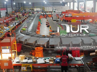 Workers of a courier company sort packages on a smart express line in Enshi, Hubei province, China, on November 13, 2024. (