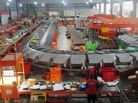 Workers of a courier company sort packages on a smart express line in Enshi, Hubei province, China, on November 13, 2024. (