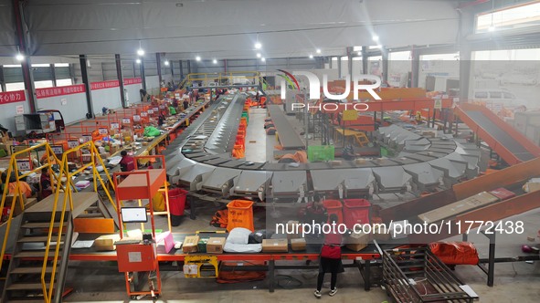 Workers of a courier company sort packages on a smart express line in Enshi, Hubei province, China, on November 13, 2024. 