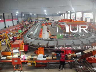 Workers of a courier company sort packages on a smart express line in Enshi, Hubei province, China, on November 13, 2024. (