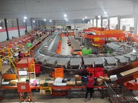 Workers of a courier company sort packages on a smart express line in Enshi, Hubei province, China, on November 13, 2024. (