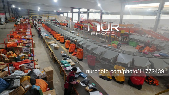 Workers of a courier company sort packages on a smart express line in Enshi, Hubei province, China, on November 13, 2024. 