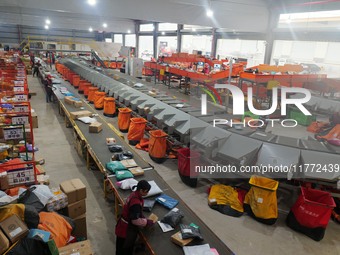 Workers of a courier company sort packages on a smart express line in Enshi, Hubei province, China, on November 13, 2024. (