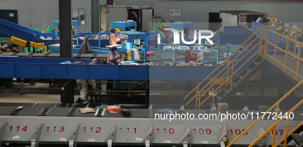 Workers of a courier company sort packages on a smart express line in Enshi, Hubei province, China, on November 13, 2024. 