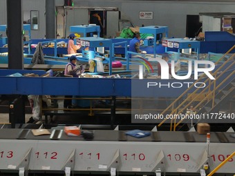 Workers of a courier company sort packages on a smart express line in Enshi, Hubei province, China, on November 13, 2024. (