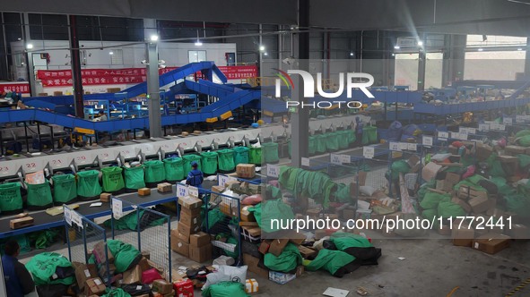 Workers of a courier company sort packages on a smart express line in Enshi, Hubei province, China, on November 13, 2024. 