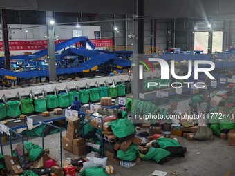 Workers of a courier company sort packages on a smart express line in Enshi, Hubei province, China, on November 13, 2024. (