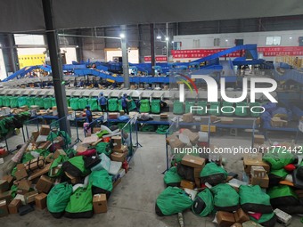 Workers of a courier company sort packages on a smart express line in Enshi, Hubei province, China, on November 13, 2024. (