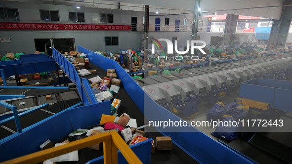 Workers of a courier company sort packages on a smart express line in Enshi, Hubei province, China, on November 13, 2024. 