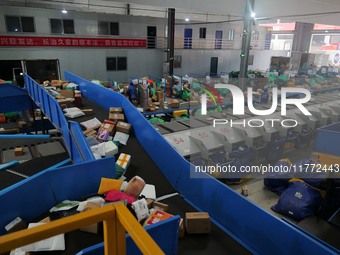 Workers of a courier company sort packages on a smart express line in Enshi, Hubei province, China, on November 13, 2024. (