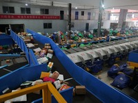 Workers of a courier company sort packages on a smart express line in Enshi, Hubei province, China, on November 13, 2024. (