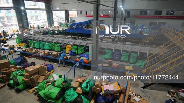 Workers of a courier company sort packages on a smart express line in Enshi, Hubei province, China, on November 13, 2024. 