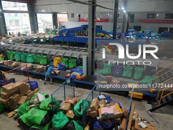 Workers of a courier company sort packages on a smart express line in Enshi, Hubei province, China, on November 13, 2024. (