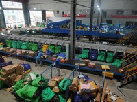 Workers of a courier company sort packages on a smart express line in Enshi, Hubei province, China, on November 13, 2024. (