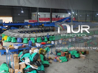 Workers of a courier company sort packages on a smart express line in Enshi, Hubei province, China, on November 13, 2024. (