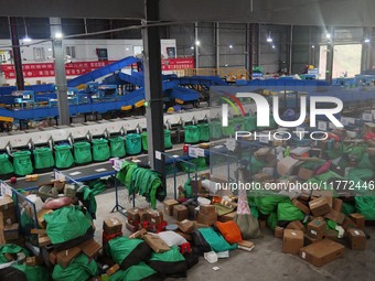 Workers of a courier company sort packages on a smart express line in Enshi, Hubei province, China, on November 13, 2024. (