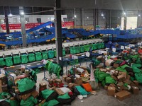 Workers of a courier company sort packages on a smart express line in Enshi, Hubei province, China, on November 13, 2024. (