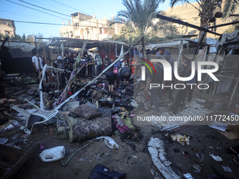 Displaced Palestinians check the damage following an Israeli strike that hits tents in Deir el-Balah in the central Gaza Strip on November 1...