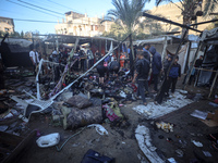 Displaced Palestinians check the damage following an Israeli strike that hits tents in Deir el-Balah in the central Gaza Strip on November 1...