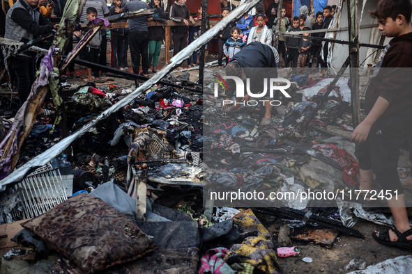 Displaced Palestinians check the damage following an Israeli strike that hits tents in Deir el-Balah in the central Gaza Strip on November 1...