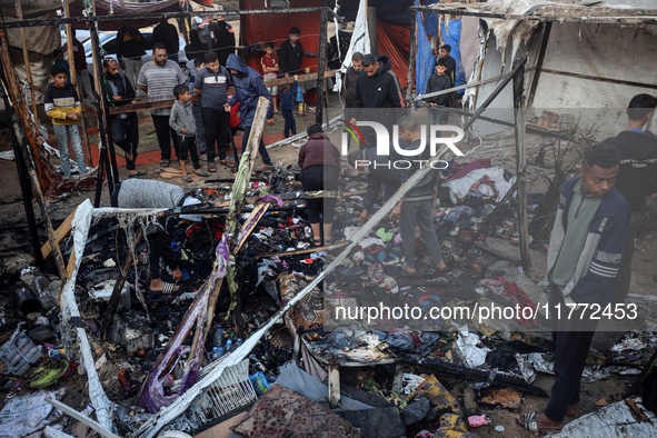 Displaced Palestinians check the damage following an Israeli strike that hits tents in Deir el-Balah in the central Gaza Strip on November 1...